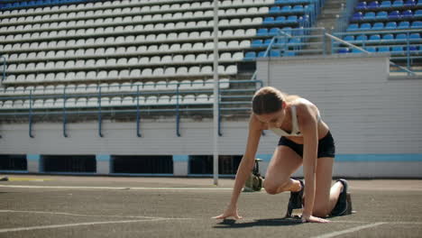 Slow-motion:-Girl-athlete-waits-for-start-of-race-in-400-meters.-girl-athlete-waits-for-start-of-race-in-100-meters-during.-Running-at-the-stadium-from-the-pads-on-the-treadmill